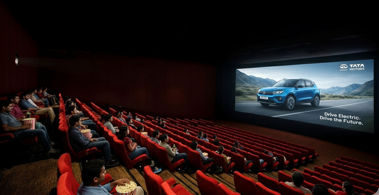 Audience in theater watching Tata Motors cinema ad featuring electric car and Drive the Future slogan. PVR Cinema Advertising Agency near Maharashtra