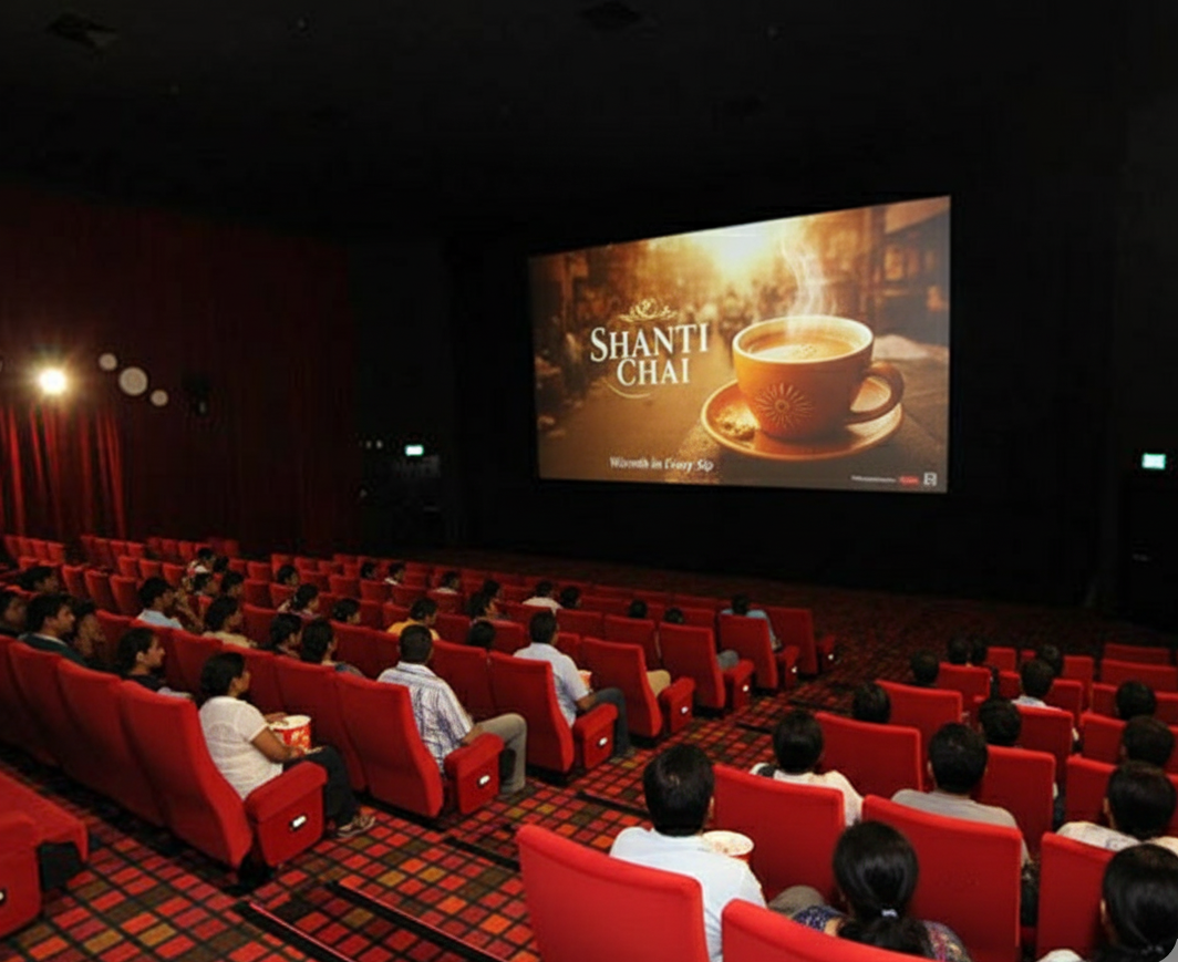 Audience in a cinema theater watching a Shanti Chai cinema ad with steaming tea and the tagline Warmth in Every Sip.