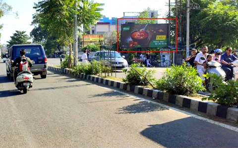 "Urban street in Jammu and Kashmir with 20x10 ft food hoarding by ACME Advertising Co., featuring bowl visual and ā¹10.4 value message; visible car, scooter, pedestrians, greenery, and digital billboard.