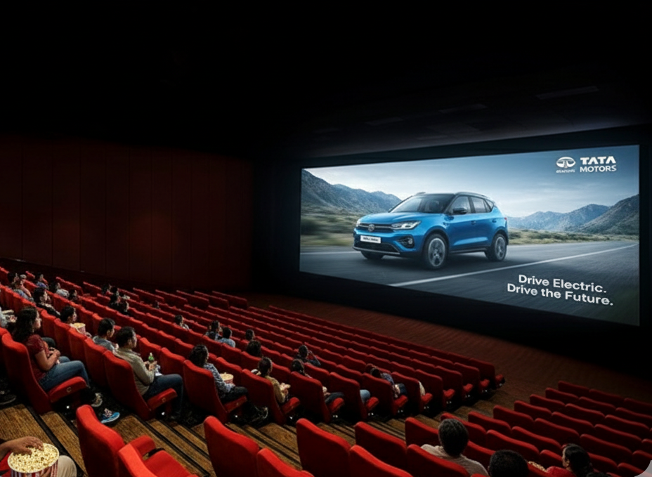 Audience in theater watching Tata Motors cinema ad featuring electric car and Drive the Future slogan. PVR Cinema Advertising Agency near Maharashtra