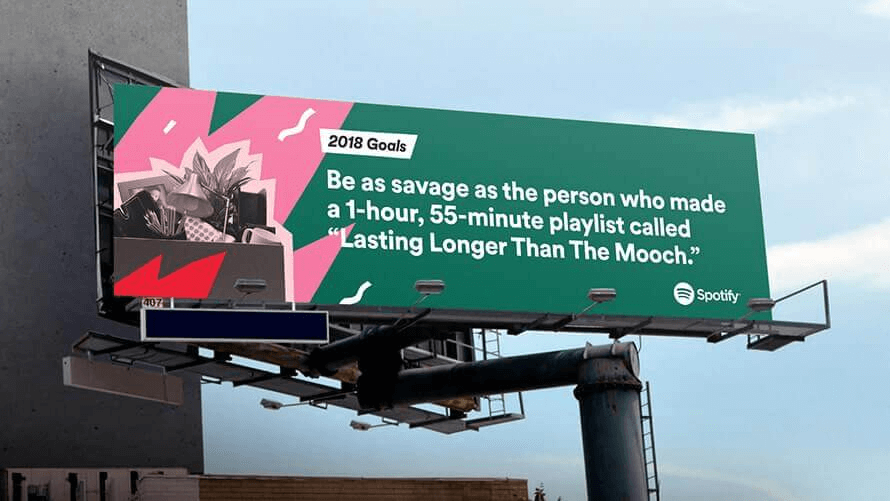 Creative outdoor billboard advertising campaign promoting Spotify music service on a large urban hoarding structure.