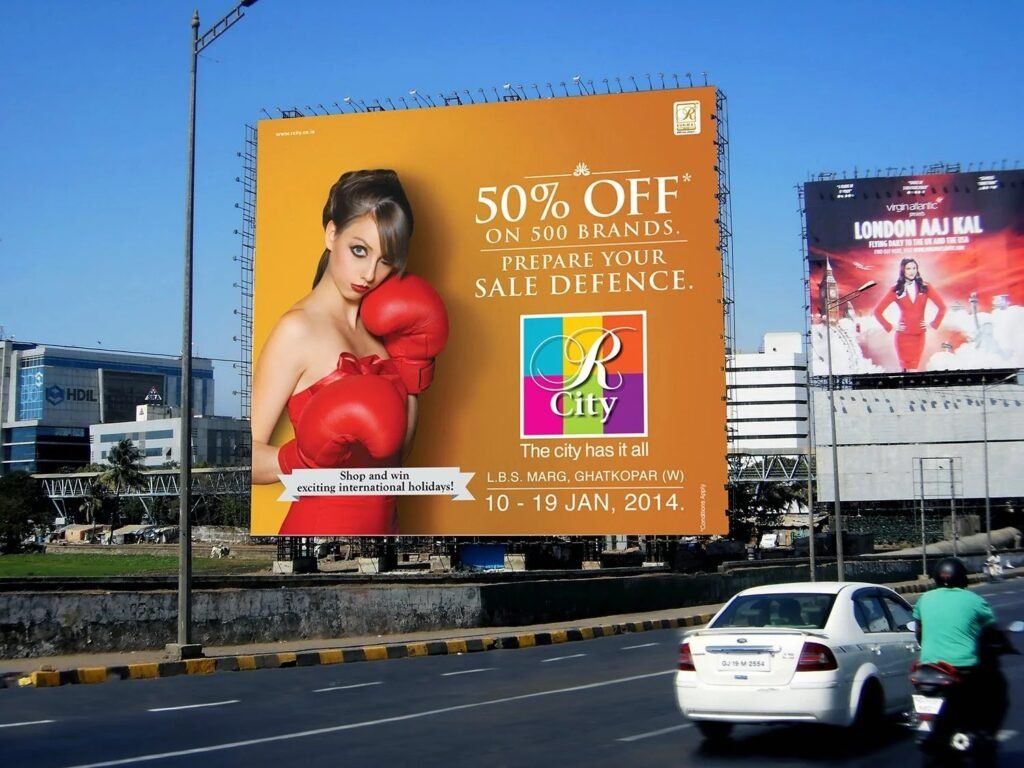 Large roadside billboard advertising promoting retail sale offer on a high-traffic highway for outdoor brand visibility.