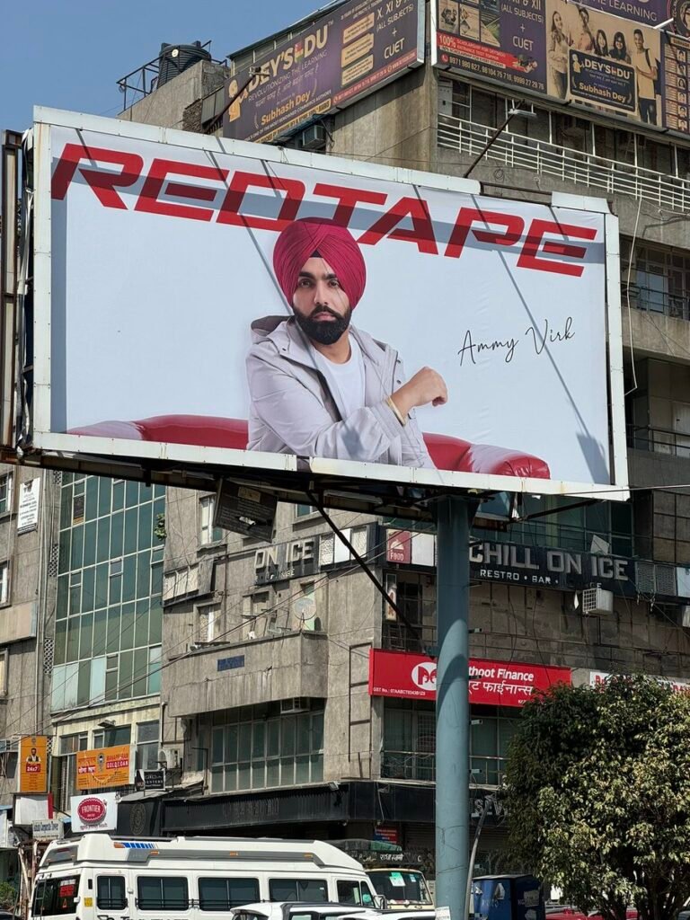 Outdoor advertisement displayed on a large billboard in a busy urban environment
