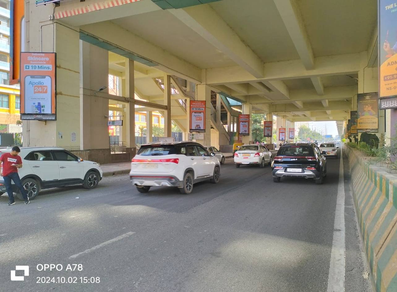 Leading unipole advertising companies in Noida offering high-impact visibility with strategic placements across key traffic routes. Large outdoor Metro Pillars by Leading unipole advertising companies in Noida offering high-impact visibility with strategic placements across key traffic routes. Advertiser displayed on a busy roadside, showcasing high-impact hoarding advertising for brand visibility in Noida