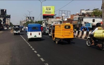 Busy street in Lucknow with a high-visibility hoarding by ACME Advertising Co., a leading name in billboard advertising companies in Lucknow.