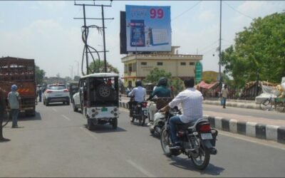 ACME Advertising Co. hoarding on a busy Lucknow street, exemplifying powerful outdoor branding through billboard advertising companies in Lucknow.