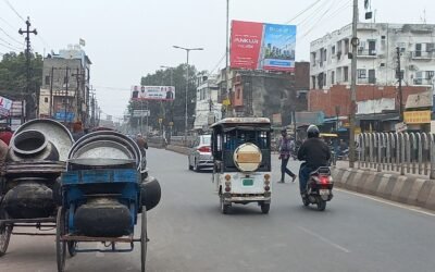 Urban street in Lucknow with Ankur billboard by ACME Advertising Co., a top name among billboard advertising companies in Lucknow, amid busy traffic.