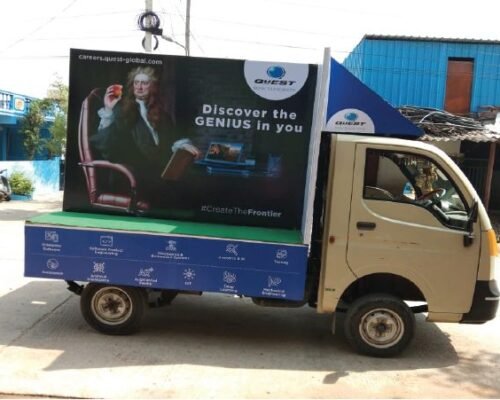 Truck advertising of QuEST Global Careers – Discover the Genius in You Truck advertising vehicle promoting QuEST Global with Newton-themed “Discover the Genius in You” campaign and digital career graphics.