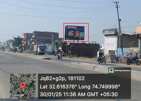 Urban street in Jammu and Kashmir with 20x10 ft Nestlé hoarding by ACME Advertising Co., featuring ₹25 offer and food visual; visible motorcycles, roadside shops, and GPS overlay with timestamp and coordinates.