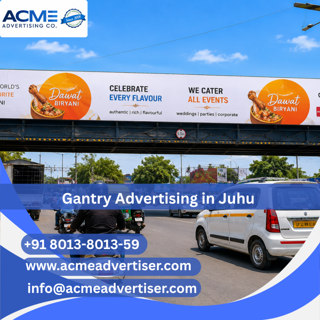 Large gantry advertising display by ACME Advertising Co. at Juhu JVPD Junction on a busy high-traffic roadway.