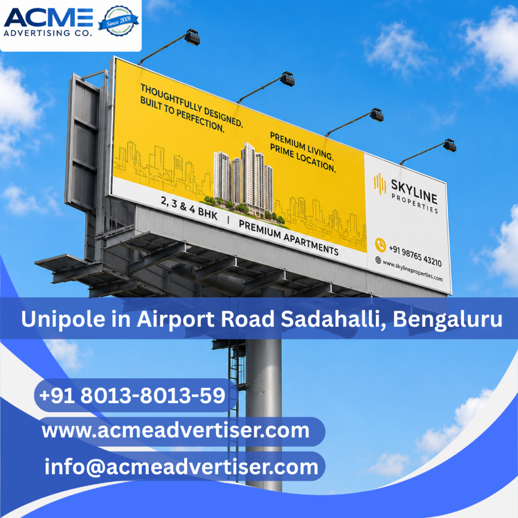 Large unipole advertising display by ACME Advertising Co. on Airport Road Sadahalli, Bengaluru at a prime high-traffic roadside location.