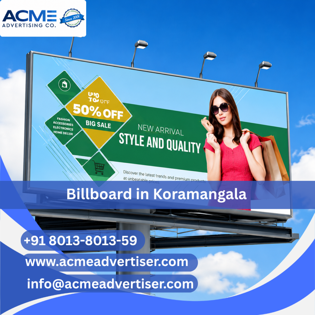 High-visibility billboard advertising display by ACME Advertising Co. in Koramangala at a busy commercial roadside location.