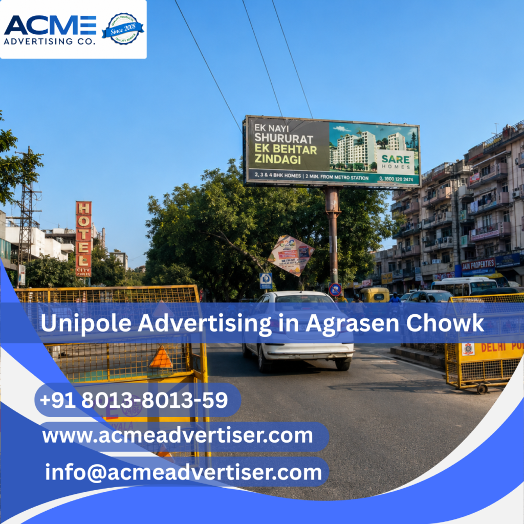 Large unipole advertising display by ACME Advertising Co. at Agrasen Chowk on a high-traffic roadside location.