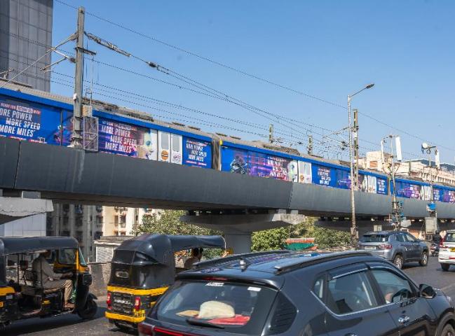 Metro train exterior panel advertising in Valnai Meeth Chowky, Mumbai - 