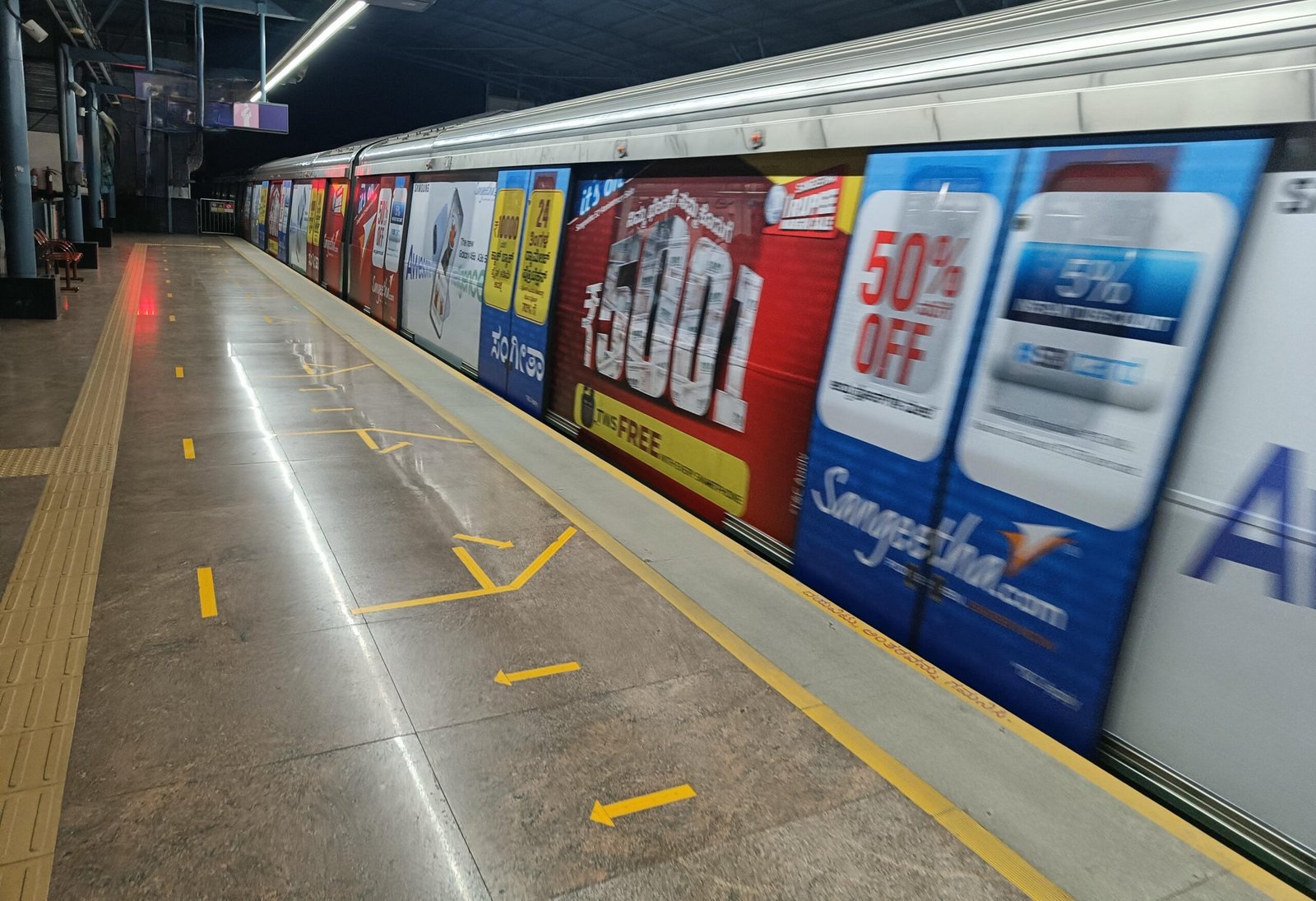 Metro train wrap advertising at Punjabi Bagh West station - 