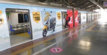 Metro train exterior wrap advertising at Yamuna Bank - 