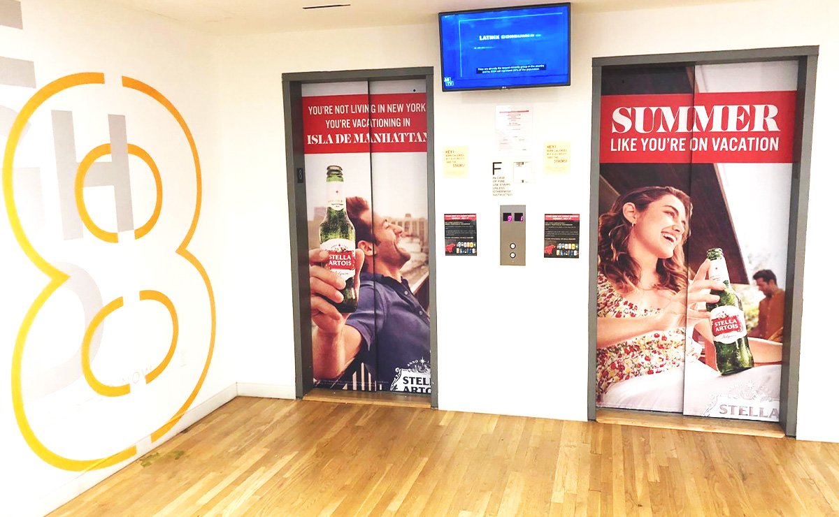 Premium lobby lift branding display by Acme Advertising