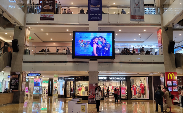 Large digital LED screen mall advertising display inside shopping mall atrium promoting entertainment campaign by ACME Advertising
